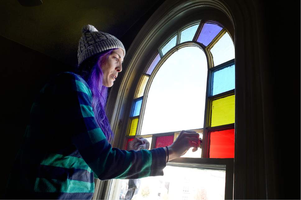 Scott Sommerdorf   |  The Salt Lake Tribune  
Jess Mikel cleans a rainbow edged window that looks out to the north with a view of the Provo LDS Temple during a work / cleanup day at the old Victorian home being renovated to house "Encircle House" which will be Provo's first LGBT resource center, Saturday November 19, 2016.