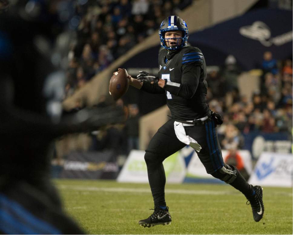 BYU quarterback Taysom Hill (7) looks to throw against Utah State during an NCAA college football game in Provo, Utah, Saturday, Nov. 26, 2016.  (Rick Egan/The Salt Lake Tribune via AP)