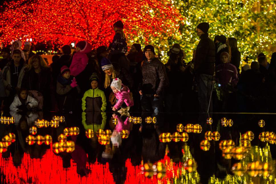 Chris Detrick  |  The Salt Lake Tribune
Visitors look at Christmas Lights on Temple Square Friday November 25, 2016. The Christmas lights will turn on every night at dusk until January 3, 2016.