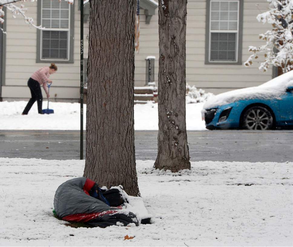 Al Hartmann  |  The Salt Lake Tribune
Homeless person hunkers down in his sleeping bag in Liberty Park during wet snowstorm Monday Nov. 28 in Salt Lake City.