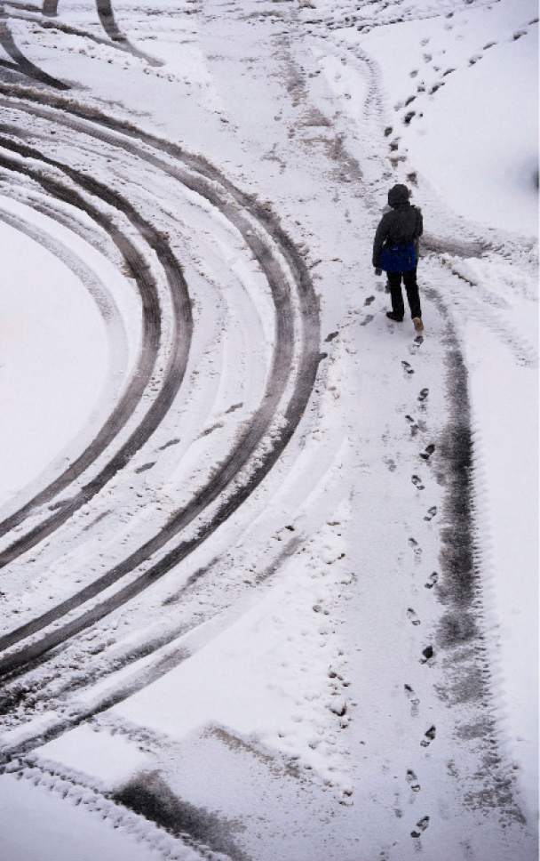 Steve Griffin / The Salt Lake Tribune


A pedestrian walks on a snow covered sidewalk on the campus of the University of Utah in Salt Lake City Monday November 28, 2016.