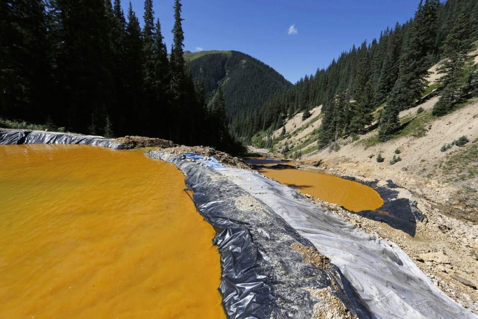 FILE - In this Aug. 14, 2015, file photo, water flows through a series of sediment retention ponds built to reduce heavy metal and chemical contaminants from the Gold King Mine wastewater accident in the spillway about 1/4 mile downstream from the mine outside Silverton, Colo. On Monday, Nov. 28, 2016, the U.S. Supreme Court asked the Justice Department to weigh in on New Mexico's lawsuit against Colorado over the Gold King mine waste spill that polluted rivers in both states and in Utah. (AP Photo/Brennan Linsley, File)