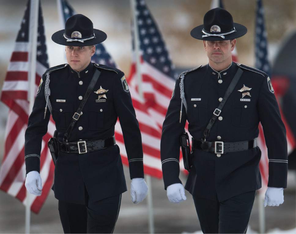 Leah Hogsten  |  The Salt Lake Tribune
l-r Idaho State Police officers Drew Francis and Aaron Bingham joined officers from Louisiana, North Carolina, New York, Wisconsin, West Virginia and Colorado to pay their respects to the family of Utah Highway Patrol Trooper Eric Ellsworth at the Willard LDS Stake Center, November 29, 2016.  Ellsworth was hit by a car on the night of November 18, 2016 while trying to alert the driver of a semitrailer truck to go around a downed power line in Box Elder County. He died four days later.