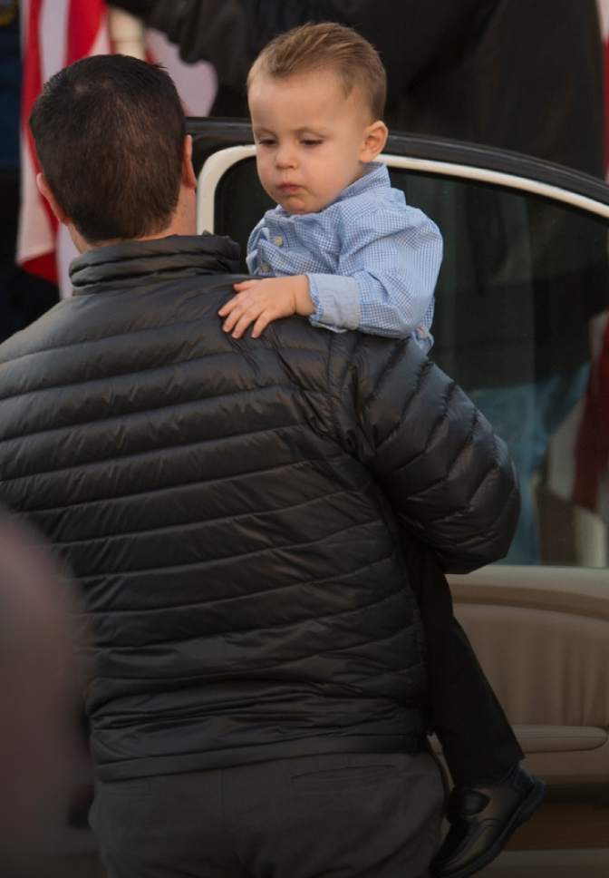 Leah Hogsten  |  The Salt Lake Tribune
Trooper Eric Ellsworth's youngest son, Oliver, is carried into the Willard LDS Stake Center by a family member, as friends, loved ones and police officers from Utah and several U.S. state agencies arrive to pay their respects to the family of Utah Highway Patrol Trooper Eric Ellsworth, who was hit by a car on the night of November 18, 2016 while trying to alert the driver of a semitrailer truck to go around a downed power line in Box Elder County. Ellsworth died four days later.
