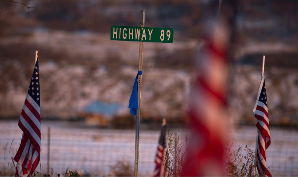 Leah Hogsten  |  The Salt Lake Tribune
Flags along Highway 89 blow in the breeze near the entrance to the Willard LDS Stake Center, as friends, loved ones and police officers from Utah and several U.S. state agencies arrive to pay their respects to the family of Utah Highway Patrol Trooper Eric Ellsworth, who was hit by a car on the night of November 18, 2016 while trying to alert the driver of a semitrailer truck to go around a downed power line in Box Elder County. Ellsworth died four days later.
