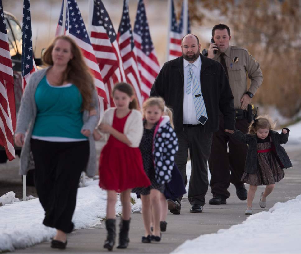 Leah Hogsten  |  The Salt Lake Tribune
"He was a good friend," said Dr. Craig Johnson of Utah Highway Patrol Trooper Eric Ellsworth, as he and his wife Stacey and their daughters entered the Willard LDS Stake Center to pay their respects to the family of Ellsworth. "He was one of the greatest guys in the world," said Johnson, "a very funny, patient guy--top notch." Ellsworth was hit by a car on the night of November 18, 2016 while trying to alert the driver of a semitrailer truck to go around a downed power line in Box Elder County. Ellsworth died four days later.