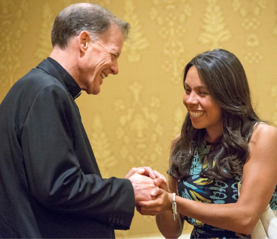 Rick Egan  |  The Salt Lake Tribune

Amee Garcia vists with departing Archbishop John C. Wester at the Little America on Sunday, May 31, 2015.