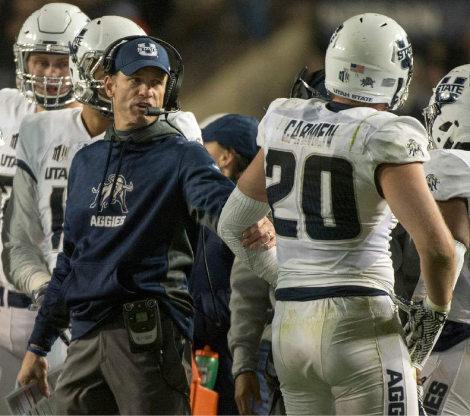 Rick Egan  |  The Salt Lake Tribune

Utah State Aggies head coach Matt Wells has a few words with Utah State Aggies linebacker Brock Carmen (20) after he was called for a personal foul, in football action, BYU vs Utah State, at Lavell Edwards Stadium in Provo,  Saturday, November 26, 2016.