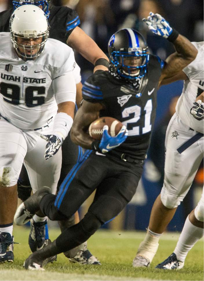 BYU running back Jamaal Williams (21) runs the ball against Utah State during an NCAA college football game in Provo, Utah, Saturday, Nov. 26, 2016.  (Rick Egan/The Salt Lake Tribune via AP)