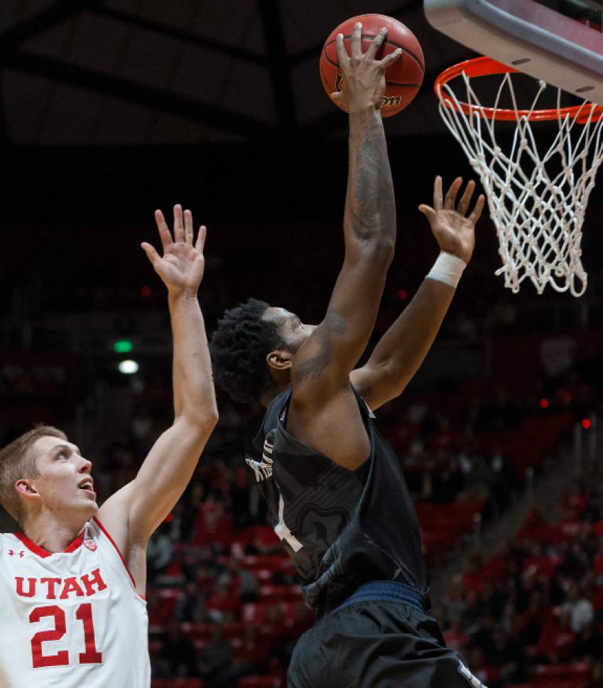 Michael Mangum  |  Special to the Tribune

Butler Bulldogs junior forward Tyler Wideman (4) drives to the hoop past Utah Utes junior forward Tyler Rawson (21) during their game at the Huntsman Center in Salt Lake City on Monday, November 28th, 2016.