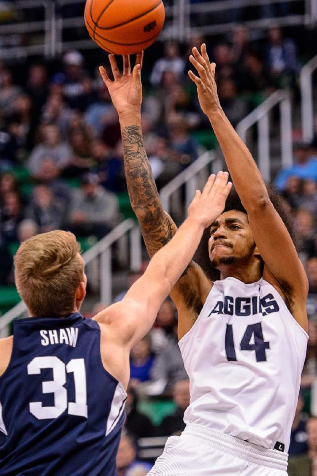 Trent Nelson  |  The Salt Lake Tribune
Utah State Aggies forward Jalen Moore (14) shoots over Brigham Young Cougars forward Braiden Shaw (31) as BYU faces Utah State, NCAA basketball in Salt Lake City, Wednesday November 30, 2016.
