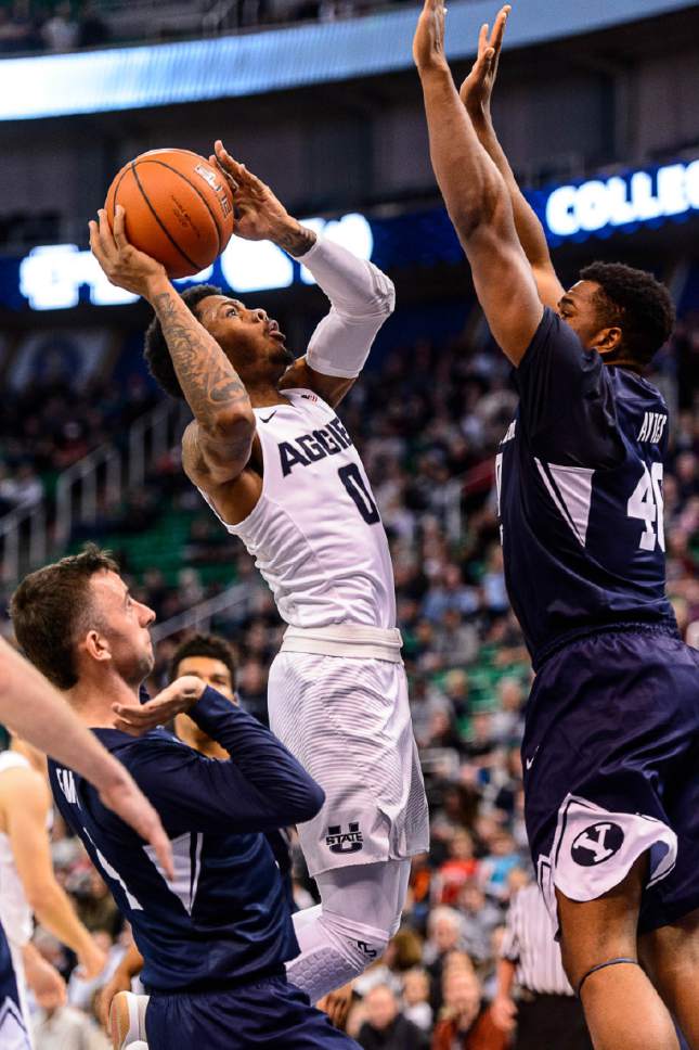 Trent Nelson  |  The Salt Lake Tribune
Utah State Aggies guard Shane Rector (0) puts up a shot with Brigham Young Cougars forward Jamal Aytes (40) defending, as BYU faces Utah State, NCAA basketball in Salt Lake City, Wednesday November 30, 2016.