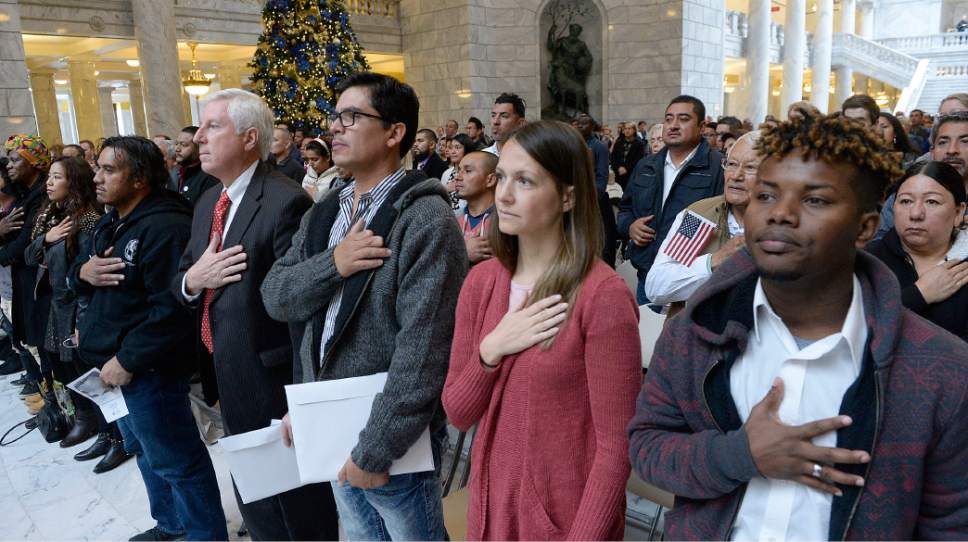 Al Hartmann  |  The Salt Lake Tribune
101 people from 43 countries stand for the National Anthem with hands over their hearts at a Naturalization Ceremony Wednesday, November 30 at the Utah State Capitol.  They later took the Oath of Allegiance to make them new American citizens.