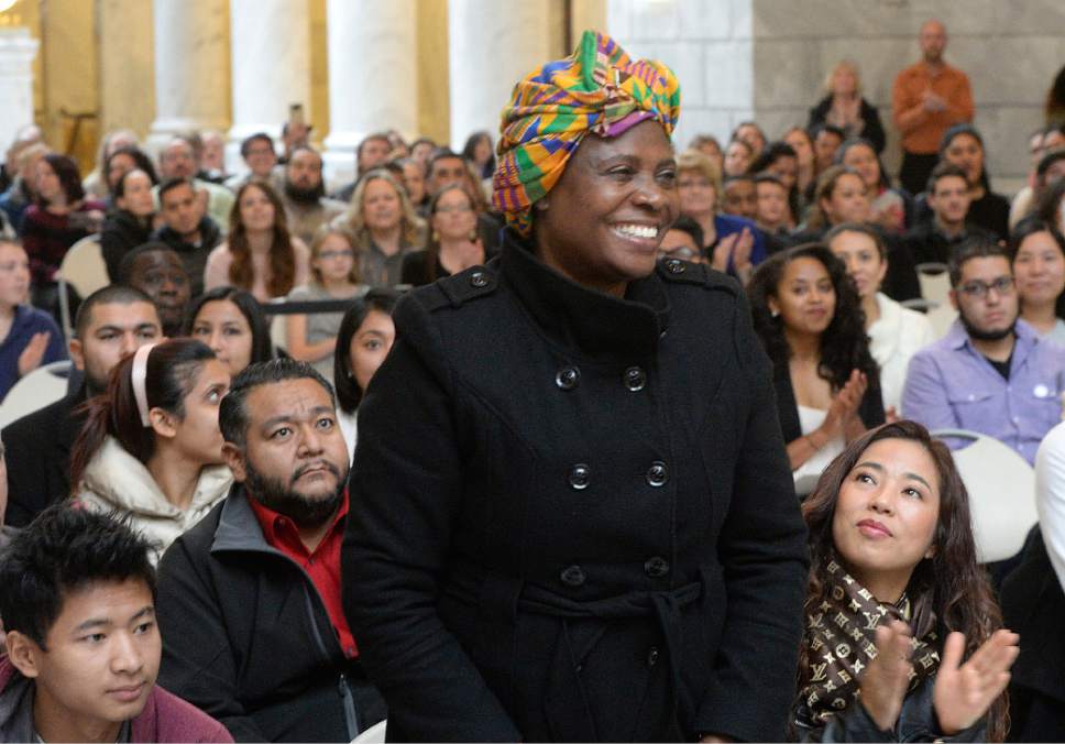 Al Hartmann  |  The Salt Lake Tribune
101 people from 43 countries take part in a Naturalization Ceremony Wednesday, November 30 at the Utah State Capitol.  They stand for applause as their former country is named.  This woman was the only person from Ghana.  They all later took the Oath of Allegiance to make them new American citizens.