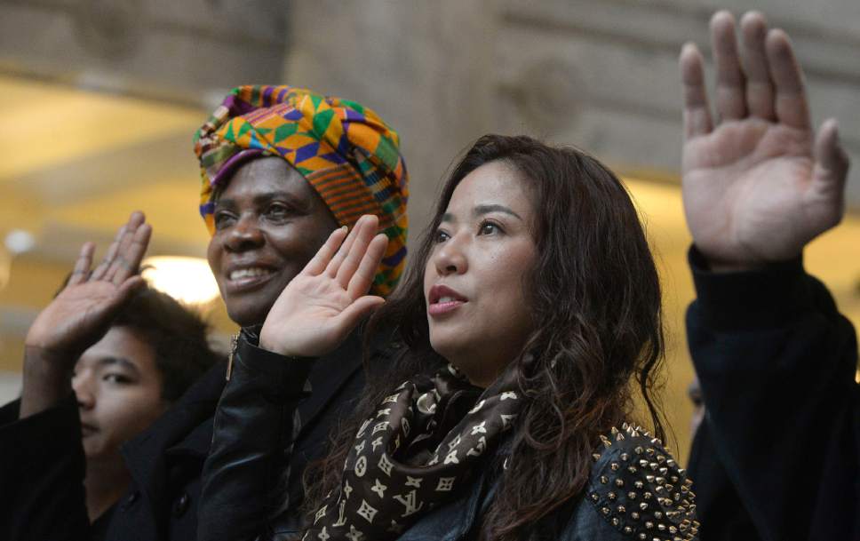 Al Hartmann  |  The Salt Lake Tribune
101 people from 43 countries raise their hands together to take the Oath of Allegiance to make them new American citizens at a Naturalization Ceremony Wednesday, November 30 at the Utah State Capitol.