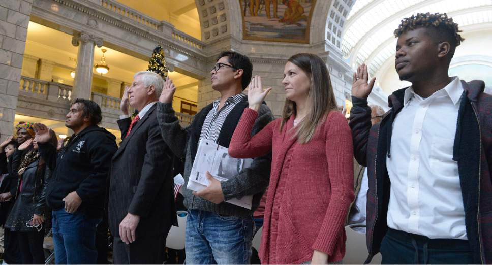 Al Hartmann  |  The Salt Lake Tribune
101 people from 43 countries raise their hands together to take the Oath of Allegiance to make them new American citizens at a Naturalization Ceremony Wednesday, November 30 at the Utah State Capitol.