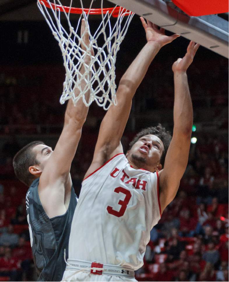 Michael Mangum  |  Special to the Tribune

Utah Utes freshman guard Devon Daniels (3) takes a shot in the paint with pressure from Butler Bulldogs senior forward Andrew Chrabascz (45) during their game at the Huntsman Center in Salt Lake City on Monday, November 28th, 2016. Daniels finished with 9 points.