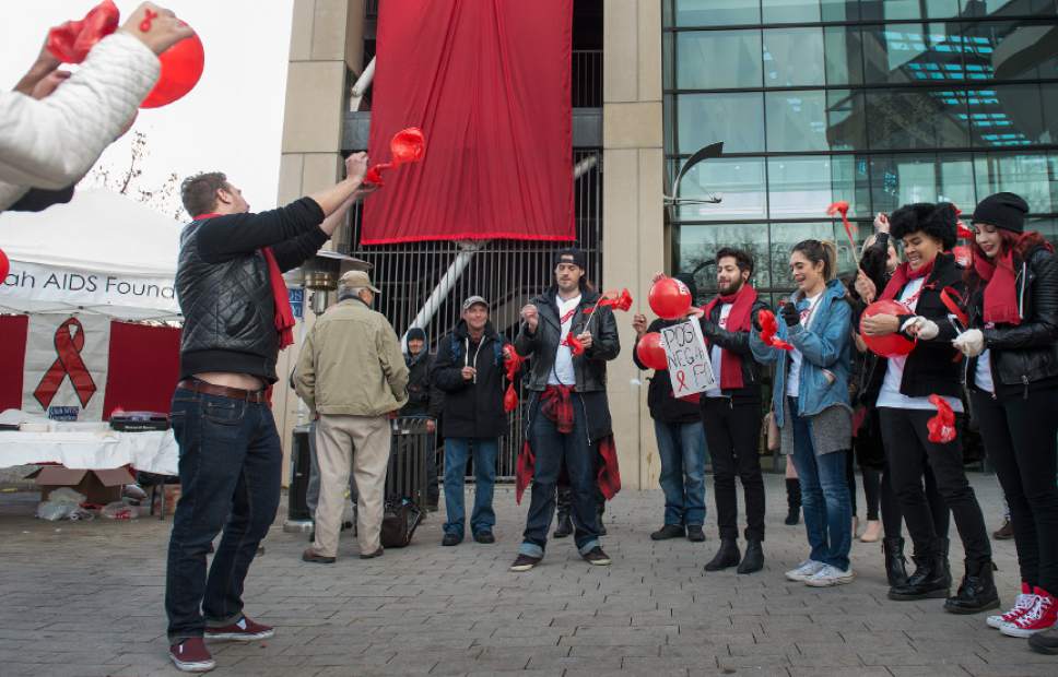 Leah Hogsten  |  The Salt Lake Tribune
In honor of World AIDs Day, anti-AIDS activists pop red balloons labeled "Stigma" in an effort to raise awareness about the stigma of AIDS.  The "Stick it to Stigma" rally started at City Creek TRAX station and ended at the Salt Lake City and County Building.