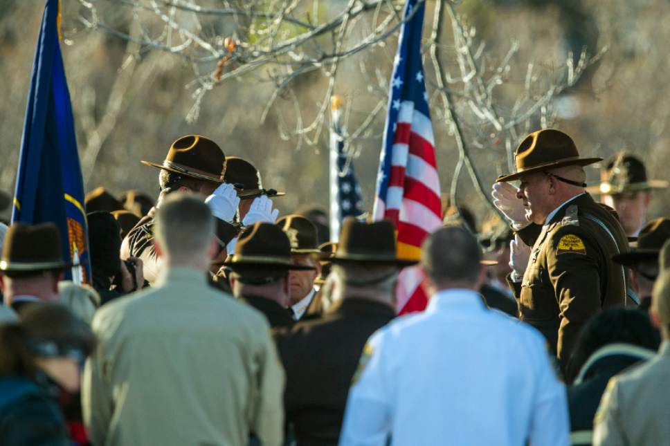 Chris Detrick  |  The Salt Lake Tribune
Members of the Utah Highway Patrol salute as the casket of during the burial of Utah Highway Patrol Trooper Eric Ellsworth at Brigham City Cemetery Wednesday November 30, 2016. Ellsworth was hit by a car on the night of November 18, 2016 while trying to alert the driver of a semitrailer truck to go around a downed power line in Box Elder County. He died four days later.