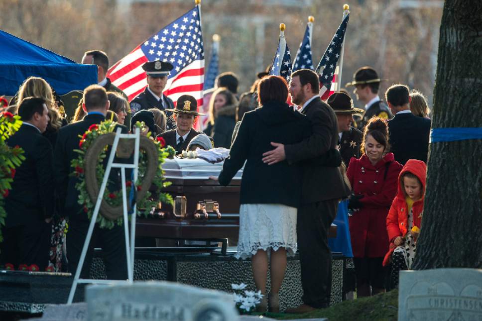Chris Detrick  |  The Salt Lake Tribune
Family, friends and law enforcement officers pay their respects during the burial of Utah Highway Patrol Trooper Eric Ellsworth at Brigham City Cemetery Wednesday November 30, 2016. Ellsworth was hit by a car on the night of November 18, 2016 while trying to alert the driver of a semitrailer truck to go around a downed power line in Box Elder County. He died four days later.