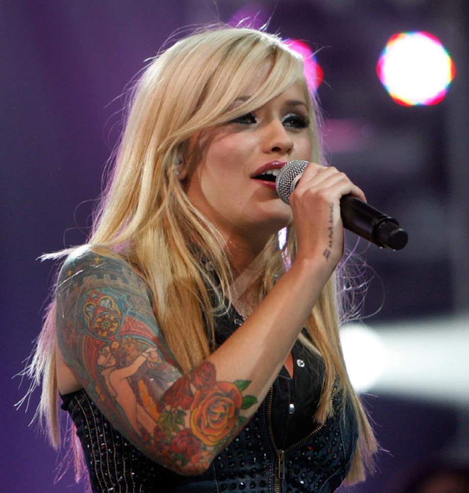 Steve Griffin  |  The Salt Lake Tribune

Megan Joy, of Sandy, sings during the final song during the American Idol concert at The E Center in West Valley City on Tuesday, July 14, 2009.