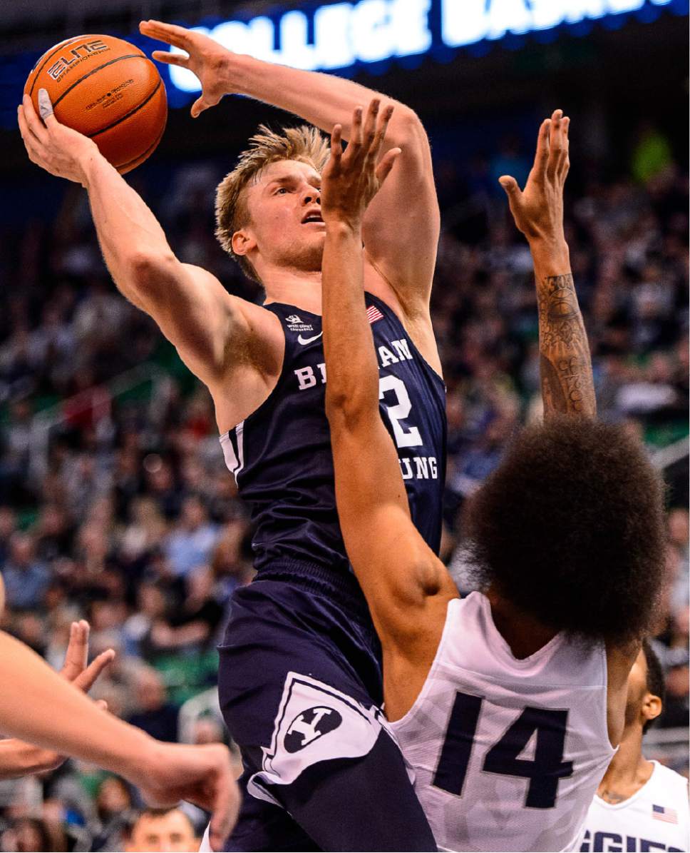 Trent Nelson  |  The Salt Lake Tribune
Brigham Young Cougars forward Eric Mika (12) shoots over Utah State Aggies forward Jalen Moore (14) as BYU faces Utah State, NCAA basketball in Salt Lake City, Wednesday November 30, 2016.