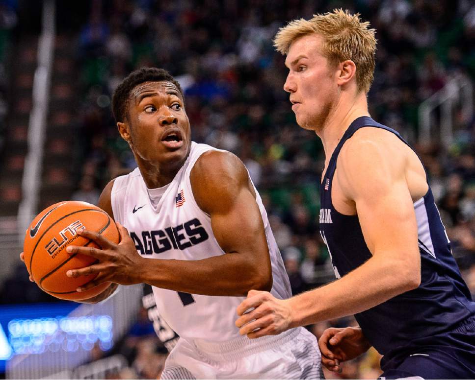 Trent Nelson  |  The Salt Lake Tribune
Utah State Aggies guard Koby McEwen (1) and Brigham Young Cougars forward Eric Mika (12) as BYU faces Utah State, NCAA basketball in Salt Lake City, Wednesday November 30, 2016.