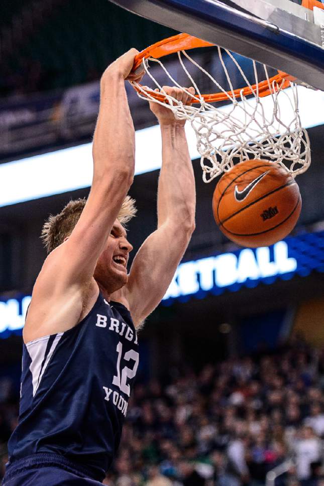 Trent Nelson  |  The Salt Lake Tribune
Brigham Young Cougars forward Eric Mika (12) dunks the ball as BYU faces Utah State, NCAA basketball in Salt Lake City, Wednesday November 30, 2016.