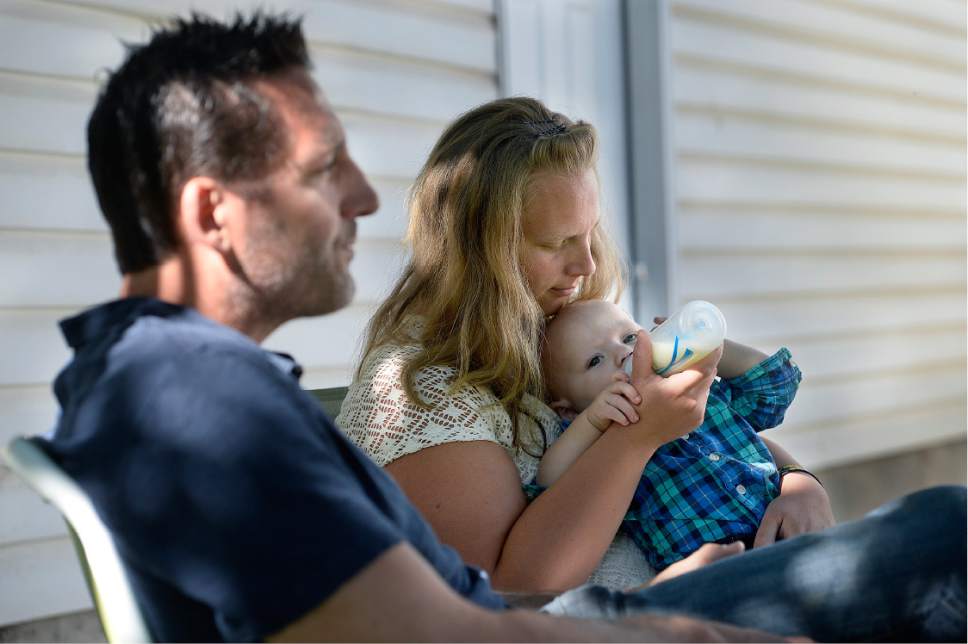Scott Sommerdorf   |  The Salt Lake Tribune  
Jayson Orvis, left, sits during an interview, as Kim Hawkins feeds her birth son at her Bountiful home, Wednesday, September 28, 2016. Hawkins was charged with first-degree murder in the death of her 13-month-old son, Billy Hawkins, despite her attorneys' assertion that there was no evidence she killed the boy. After more than a year in jail awaiting trial, she pleaded guilty to a misdemeanor and was released but still insists that she's innocent.