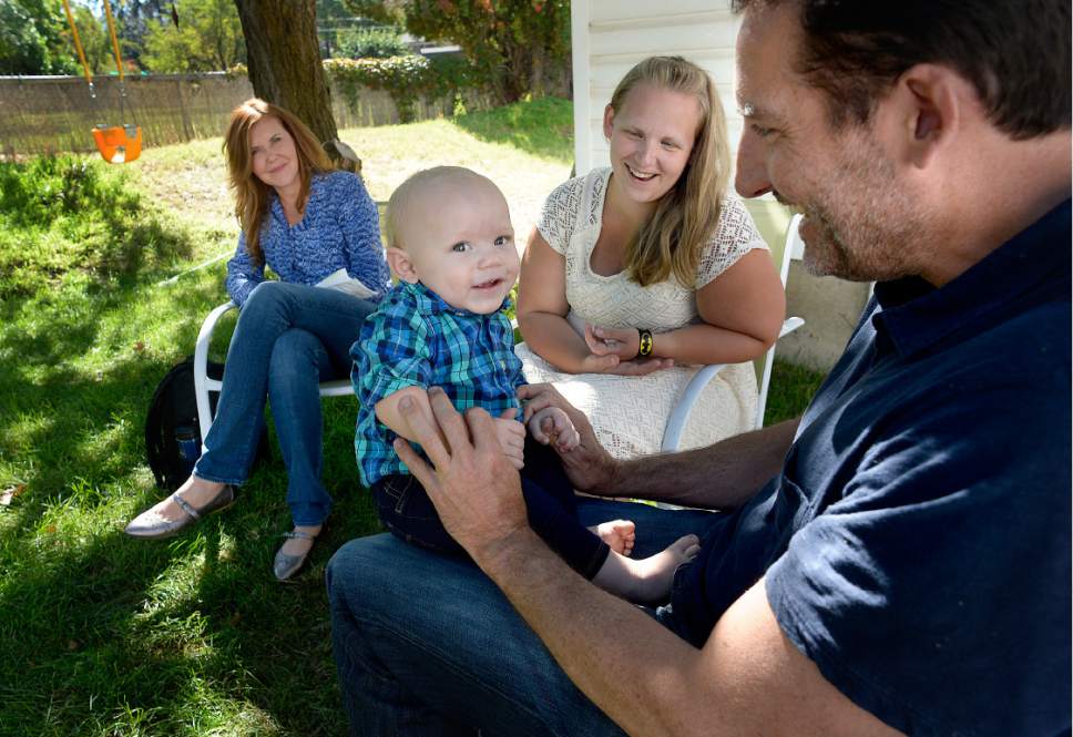 Scott Sommerdorf   |  The Salt Lake Tribune  
Pamela Orvis, left, Kim Hawkins, and Jayson Orvis, right, play with their young son during a visit to the Bountiful home of the baby's birth mother, Kim Hawkins, Wednesday, September 28, 2016. The Orvises are the adoptive parents of the boy.