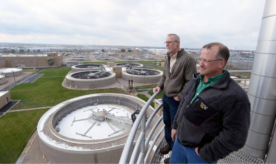 Al Hartmann  |  The Salt Lake Tribune
Tom Holstrom General Manager, left, and Phil Heck, Assistant General Manager at the Central Valley Water Reclamation Facilty look across the acres of tanks and clarifiers from the top of one of the giant egg digesters.  The 30-year-old Central Valley Water Reclamation Facilty that serves five districts and two municipalities is in need of upgrades that will cost an estimated $250 million and that means fee hikes are coming for tens of thousands of Salt Lake Valley residents and businesses.
