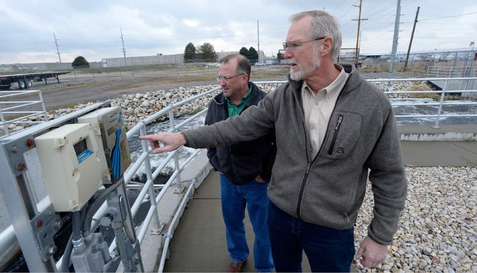 Al Hartmann  |  The Salt Lake Tribune
Phil Heck, Assitant General Manager, left and Tom Holstrom General Manager at the Central Valley Water Reclamation Facilty check the flow meter of treated and aerated sewage water as it leaves the plant and enters Millcreek and then the Jordan River half a mile later.  The 30-year-old Central Valley Water Reclamation Facilty that serves five districts and two municipalities is in need of upgrades that will cost an estimated $250 million and that means fee hikes are coming for tens of thousands of Salt Lake Valley residents and businesses.