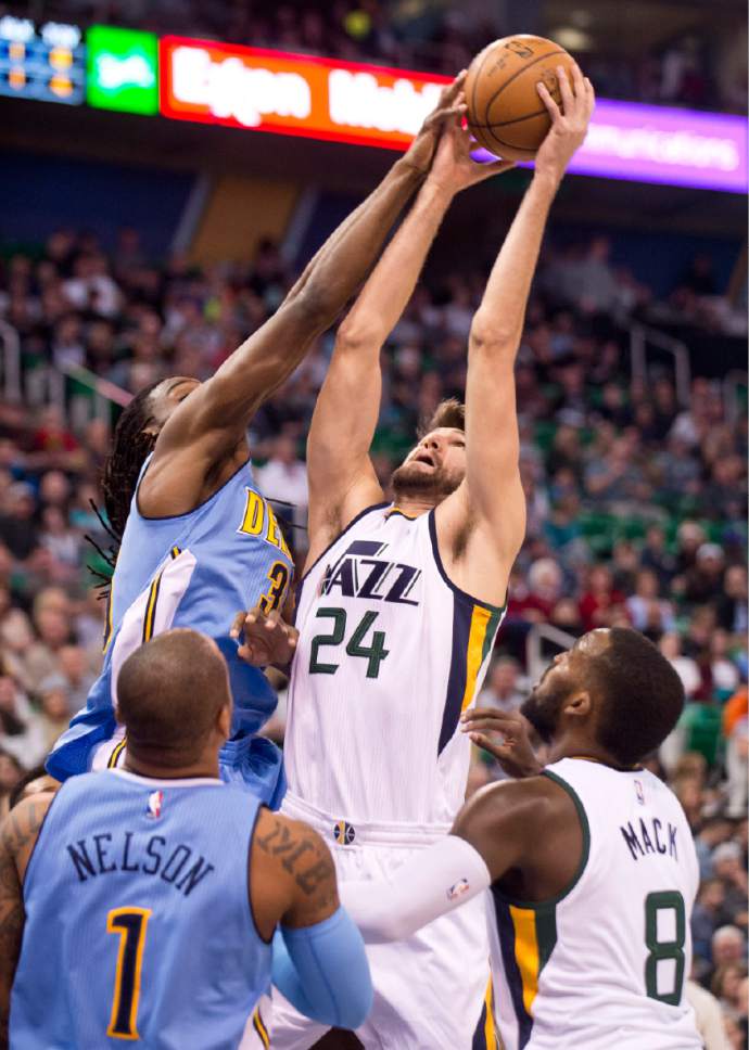 Lennie Mahler  |  The Salt Lake Tribune

Utah Jazz center Jeff Withey corrals a rebound over Denver'sKenneth Faried in the first half of a game at Vivint Smart Home Arena in Salt Lake City, Saturday, Dec. 3, 2016.