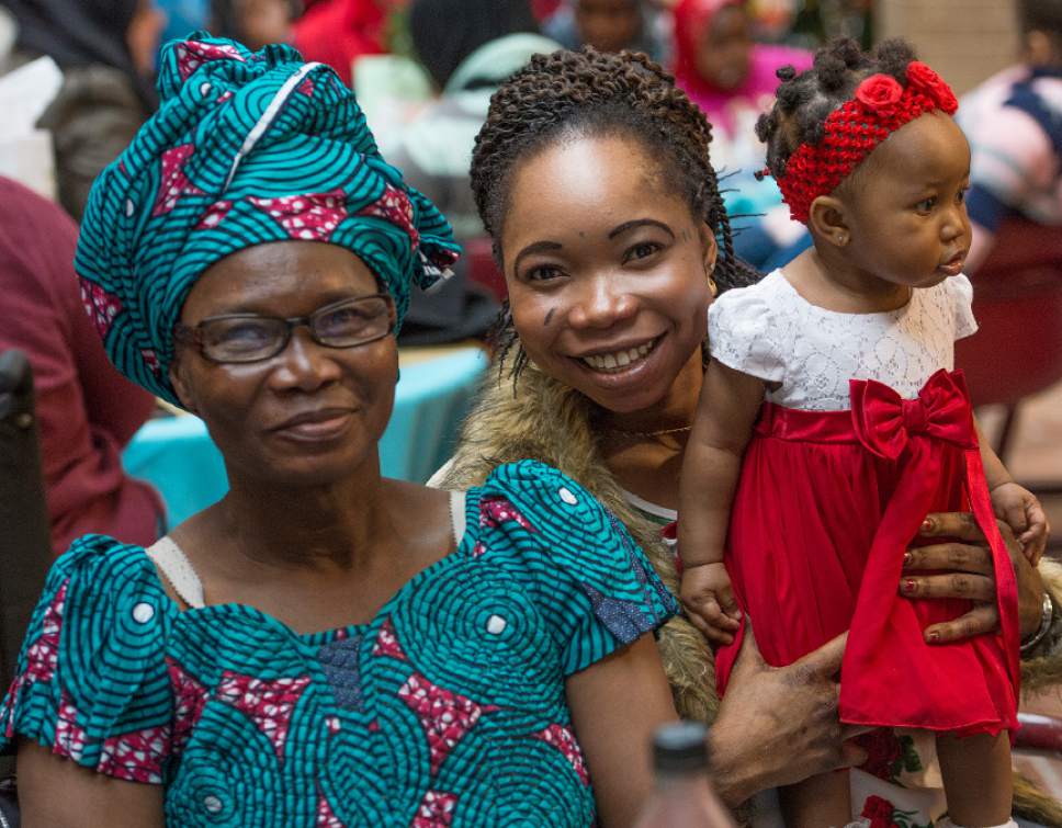 Leah Hogsten  |  The Salt Lake Tribune
Elizabeth Ngaba, 60, left, escaped war, oppression and poverty in Central African Republic with her daughter Syntishe Ngaba, two other children and her paralyzed mother. Elizabeth, Syntishe and her daughter, Blessing had much to be thankful for at the sixth annual Women of the World celebration on Saturday at the Salt Lake County South Building. Women of the World is a Utah-based human-rights group that helps refugee women develop skills, self-reliance and integrate into the community.