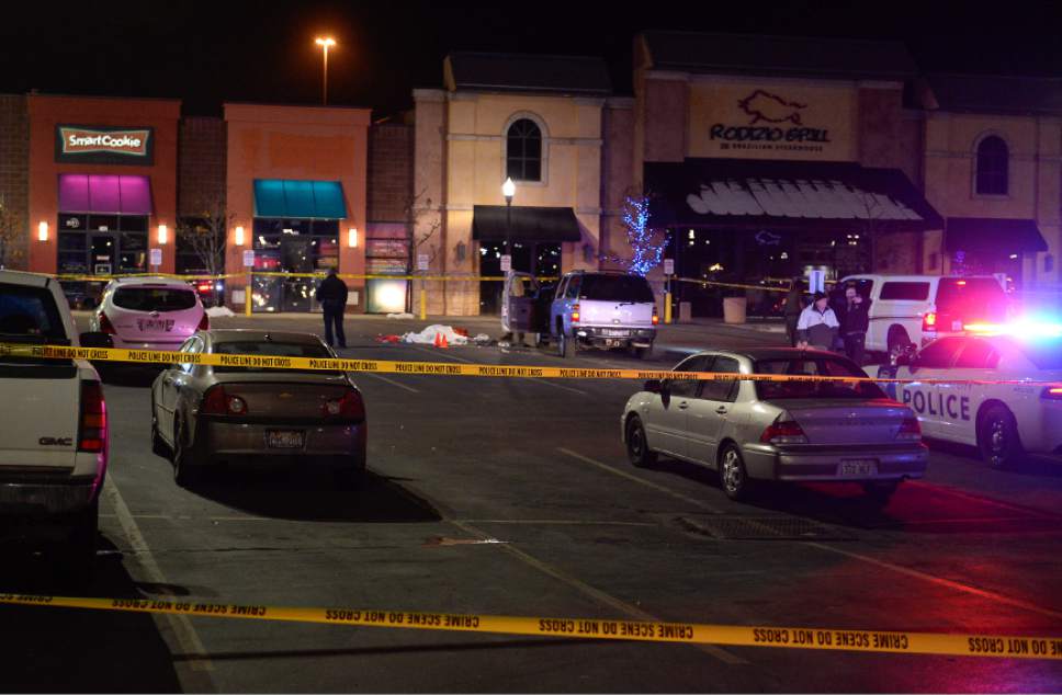 Francisco Kjolseth | The Salt Lake Tribune
Officers respond to the scene near a Cinemark in American Fork where a suspect lies dead in the parking lot on Sunday, Dec. 4, 2016. The suspect allegedly fled from a nearby Walmart  after shooting and killing a woman in her car. Following a brief pursuit by police to the Cinemark, officers fired at the suspect when he refused to drop his weapon.