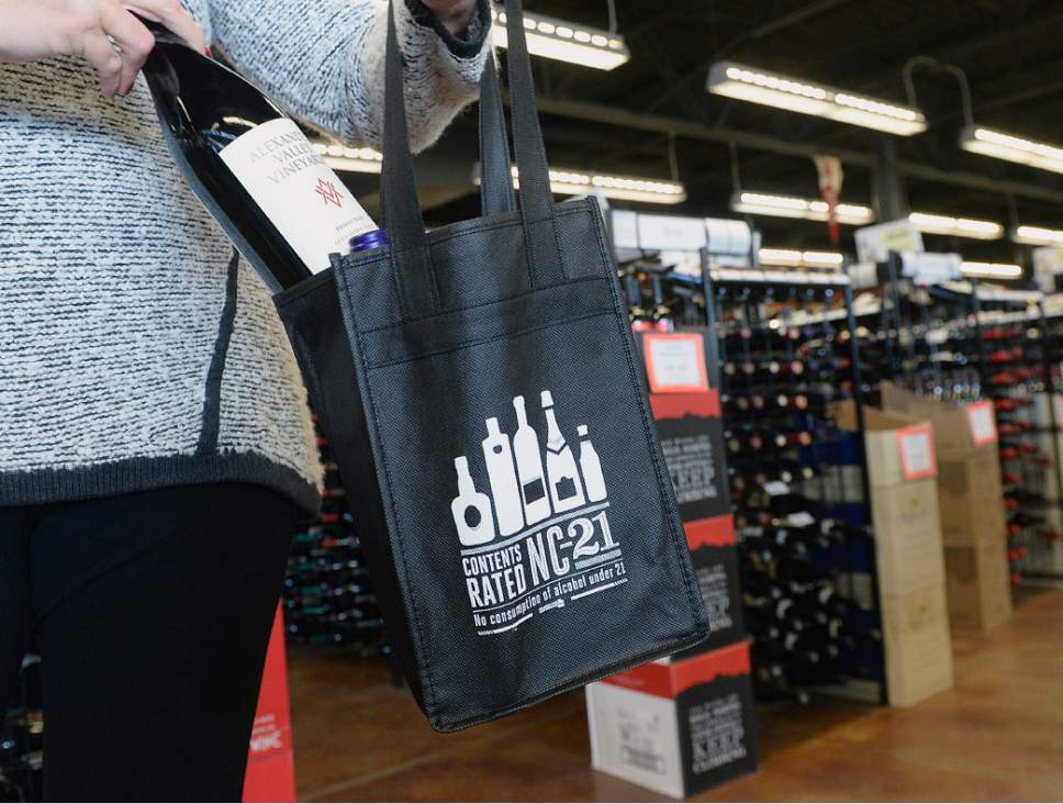 Al Hartmann  |  The Salt Lake Tribune
Utah consumers now can carry wine and spirits home in something more fashionable Û and eco-friendly Û than a brown paper bag or empty liquor box.
This week the state-owned liquor stores began offering reusable bags to customers. The  black cloth bags, available on a first-come first served-basis, have four compartments that can carry standard 750 ml bottles of wine or spirits. The front of the bags carry a message about preventing underage drinking.