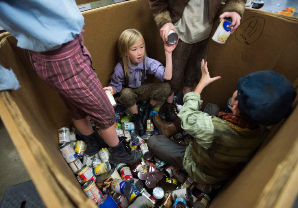 Steve Griffin | The Salt Lake Tribune


Afton Higbee -- an actress from Pioneer Theatre Company's production of "Oliver!" -- sorts food with fellow cast members after they performed a song from the play at the Utah Food Bank in Salt Lake City Monday December 5, 2016. Charles Dickens' Oliver! is about a fearless orphan in search of love and his next meal and forced into a life of pick-pocketing. Patrons of Pioneer Theatre Company's  family production will be bringing food donations to the shows throughout the holiday run of the show through Dec. 17, 2016.