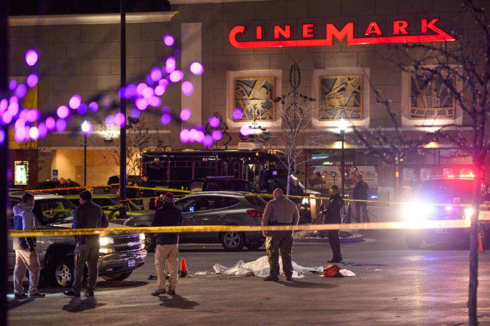 Francisco Kjolseth | The Salt Lake Tribune
The body of a male suspect lies in the parking lot of the Cinemark in American Fork where he was shot at by police following brief pursuit on Sunday night, Dec. 4, 2014. Police said he may have died from a self-inflicted gunshot. The suspect is believed to have just shot and killed a woman in her car by a Walmart nearby.