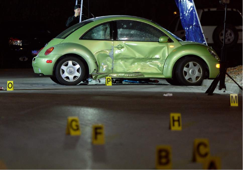 Francisco Kjolseth | The Salt Lake Tribune
Multiple bullet holes speckle the side of a VW in the far end of the Walmart parking lot, where a woman was shot and killed on Sunday night, Dec. 4, 2016. The suspect was soon pursued to the nearby Cinemark where officers fired at the suspect when he refused to drop his weapon. The suspect died at the scene, but may have shot himself, police said.