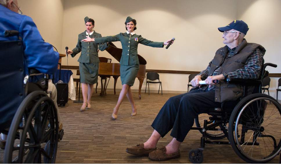 Leah Hogsten  |  The Salt Lake Tribune
l-r The Benson Sisters, Julie Surjopolos and Lisa Benson perform after the renaming ceremony, singing Glen Miller hits from the 1940's after the ceremony as  Central Utah Veterans Home resident Bill Ritch, right, watches.  In commemoration of the 75th anniversary of the Japanese attack on Pearl Harbor December 7, 1941, the Central Utah Veterans Home in Payson renamed its facility after Utah's own Capt. Mervyn Sharp Bennion. Bennion, a U.S. Naval Academy graduate from Vernon,  was in command of the USS West Virginia battleship on the morning of Dec. 7, 1941, as Japanese airplanes attacked the U.S. fleet in Hawaii. Bennion was awarded the Medal of Honor for his actions during that day, which ultimately cost him his life.