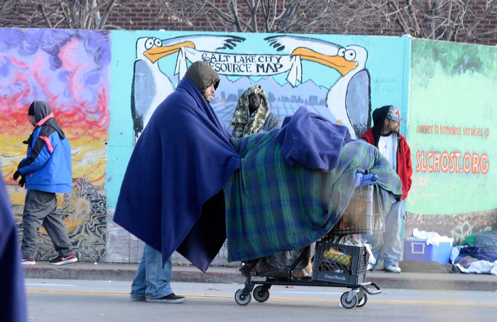 Al Hartmann  |  The Salt Lake Tribune
Bundled up homeless people in blankets and winter clothing either hunker down in place or keep walking to stay warm along 500 West near the Road Home shelter on a cold morning Wedneday Dec. 7.  
The Collective Impact steering committee met today to review a survey of homeless people in the Rio Grande area to determine if more overflow shelter space is needed.