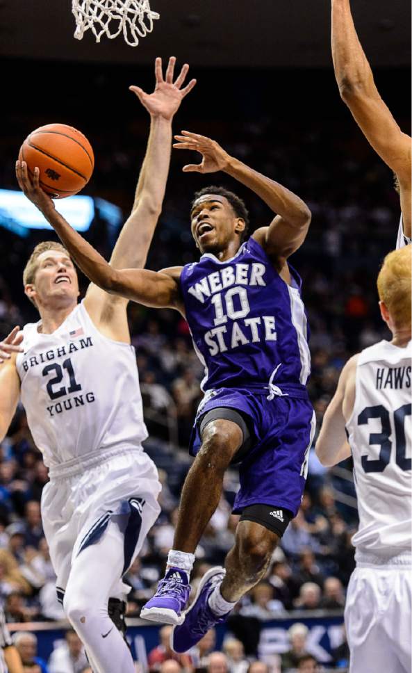Trent Nelson  |  The Salt Lake Tribune
Weber State Wildcats guard Jerrick Harding (10) puts up a shot ahead of Brigham Young Cougars forward Kyle Davis (21) as BYU hosts Weber State, NCAA basketball at the Marriott Center in Provo, Wednesday December 7, 2016.