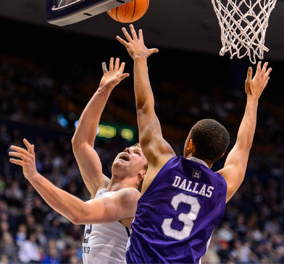 Trent Nelson  |  The Salt Lake Tribune
Brigham Young Cougars forward Eric Mika (12) shoots over Weber State Wildcats center Jordan Dallas (3) as BYU hosts Weber State, NCAA basketball at the Marriott Center in Provo, Wednesday December 7, 2016.