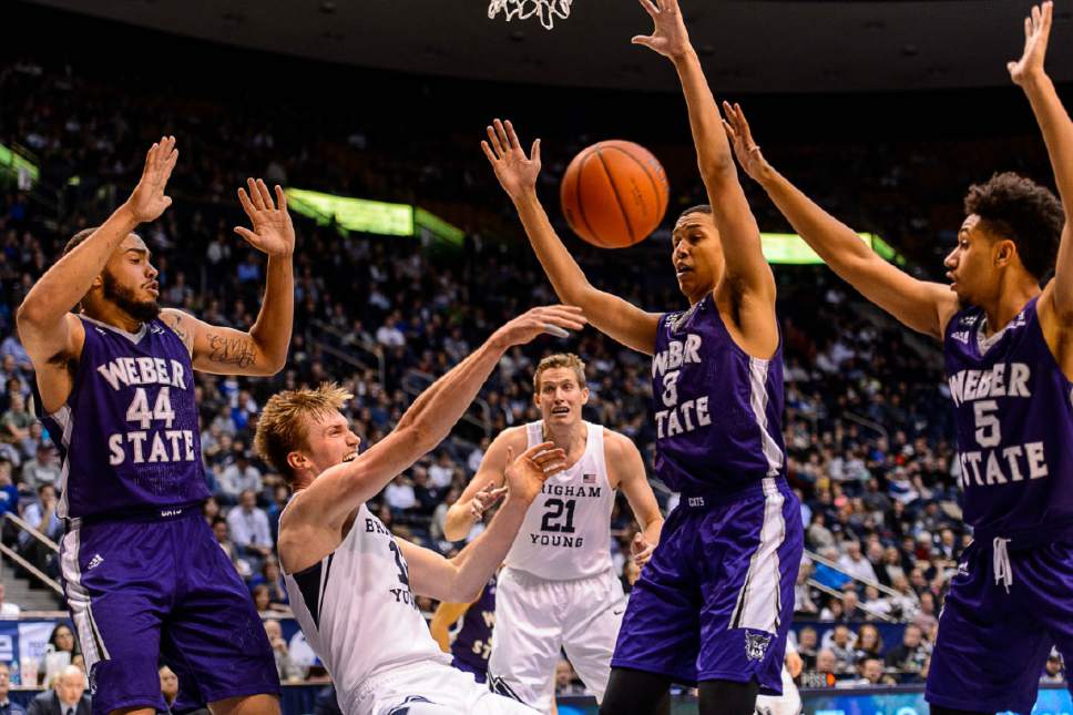 Trent Nelson  |  The Salt Lake Tribune
Brigham Young Cougars forward Eric Mika (12) passes the ball as he falls, as BYU hosts Weber State, NCAA basketball at the Marriott Center in Provo, Wednesday December 7, 2016.