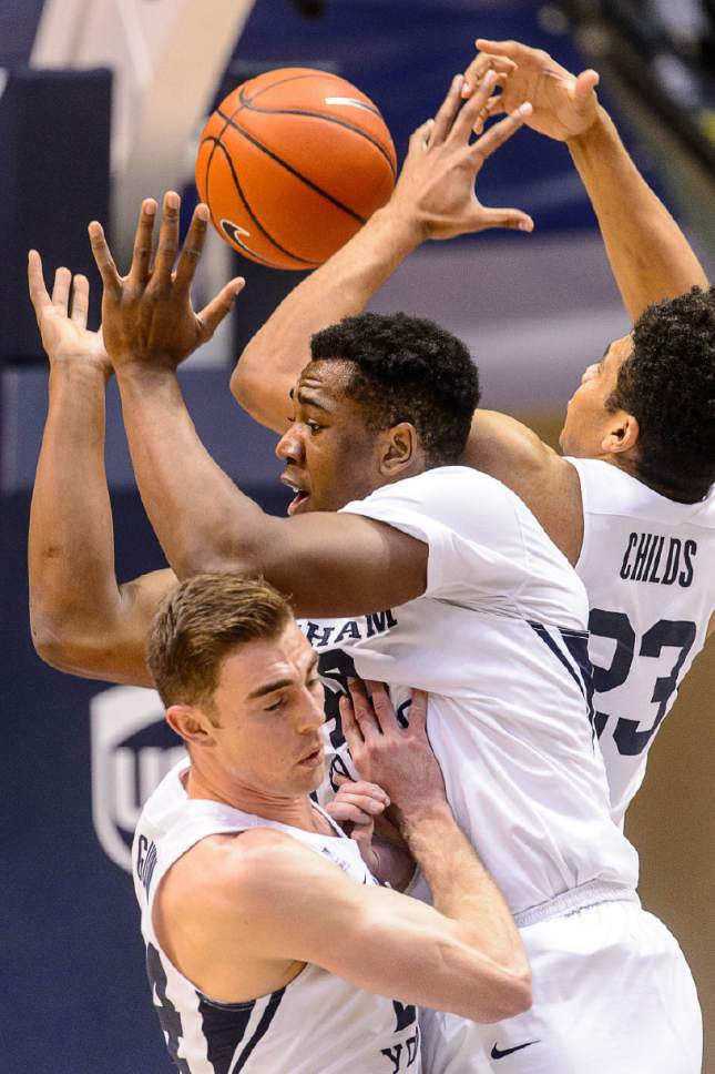 Trent Nelson  |  The Salt Lake Tribune
Brigham Young Cougars forward Davin Guinn (24), forward Jamal Aytes (40) and  forward Yoeli Childs (23) grasp for the rebound as BYU hosts Weber State, NCAA basketball at the Marriott Center in Provo, Wednesday December 7, 2016.