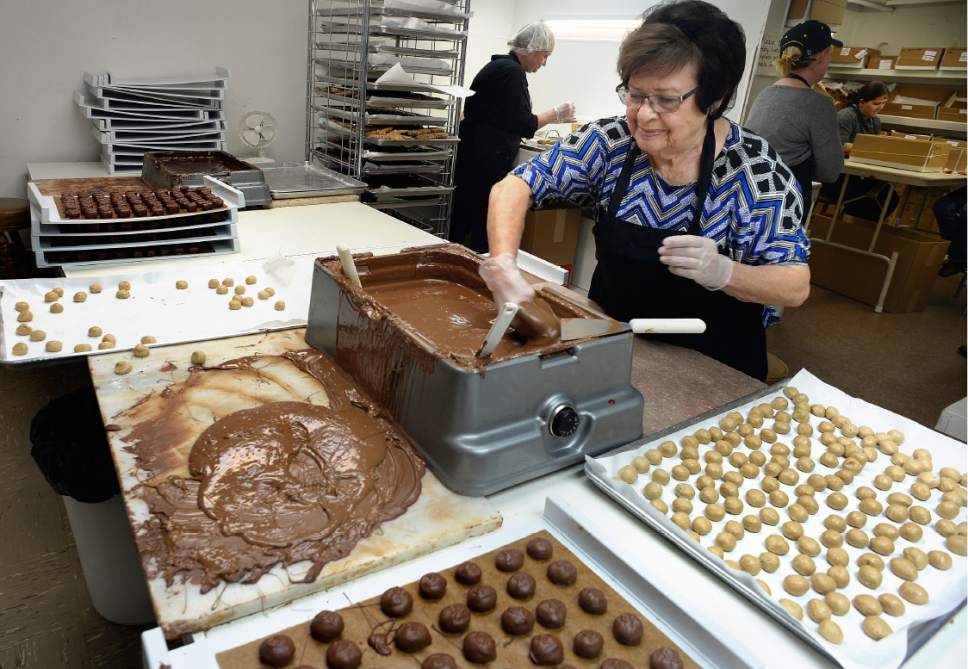 Scott Sommerdorf   |  The Salt Lake Tribune  
Jerry Condie works covering penuche filling with fresh chocolate in the Condie candy factory in Salt Lake City, Thursday, Dec. 1, 2016.