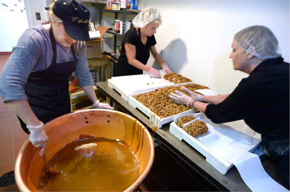 Scott Sommerdorf   |  The Salt Lake Tribune  
Nannette Condie, left, works with Karen Cunningham and Shelly Helm, right, to make pecan logs at the Condie candy factory in Salt Lake City, Thursday, Dec. 1, 2016.