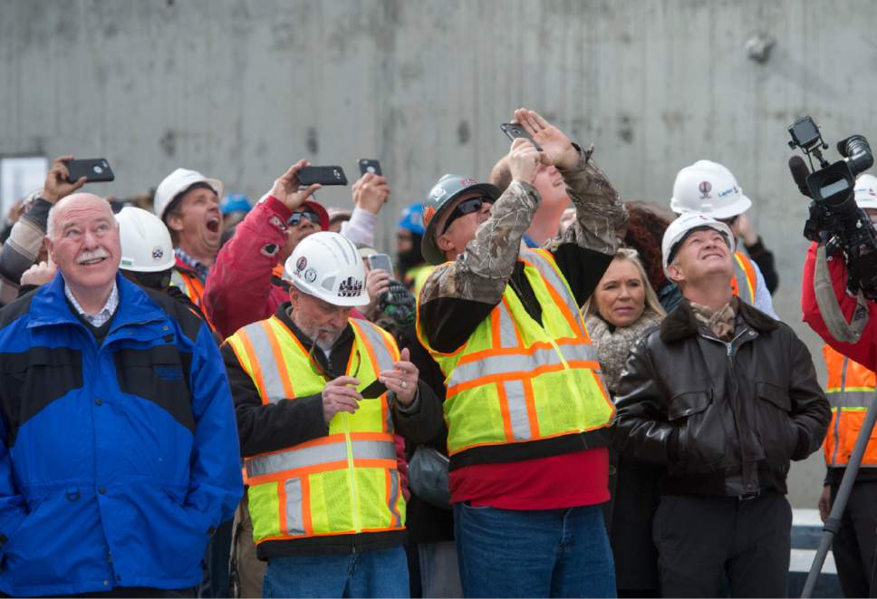 Rick Egan  |  The Salt Lake Tribune

Sandy Mayor Tom Dolan, left, watches as construction workers raise a 16-foot, 660-pound, signed white beam and an evergreen tree. The topping off ceremony is a traditional Scandinavian rite that celebrates a safe and successful construction project at the Hale Centre Theatre, in Sandy City, Friday, December 9, 2016.