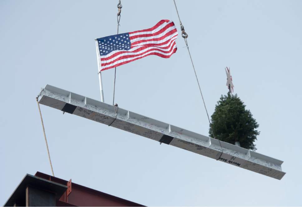 Rick Egan  |  The Salt Lake Tribune

Construction workers raise a 16-foot, 660-pound, signed white beam and an evergreen tree. The topping off ceremony is a traditional Scandinavian rite that celebrates a safe and successful construction project at the Hale Centre Theatre, in Sandy City, Friday, December 9, 2016.