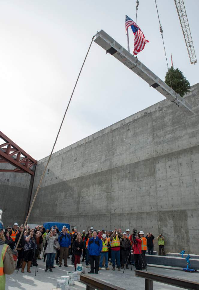 Rick Egan  |  The Salt Lake Tribune

Onlookers watch as construction workers raise a 16-foot, 660-pound, signed white beam and an evergreen tree. The topping off ceremony is a traditional Scandinavian rite that celebrates a safe and successful construction project at the Hale Centre Theatre, in Sandy City, Friday, December 9, 2016.